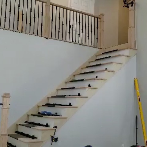 Mack finishing up some custom Oak and Wrought Iron staircase and landing