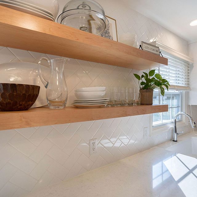 Herringbone pattern subway tile and floating shelves looking great together! A kitchen remodel from last year.